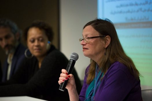 woman holding a microphone speaking