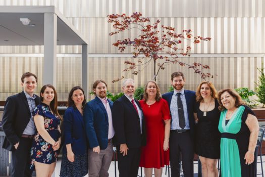 Group of gala attendees gathers outside.