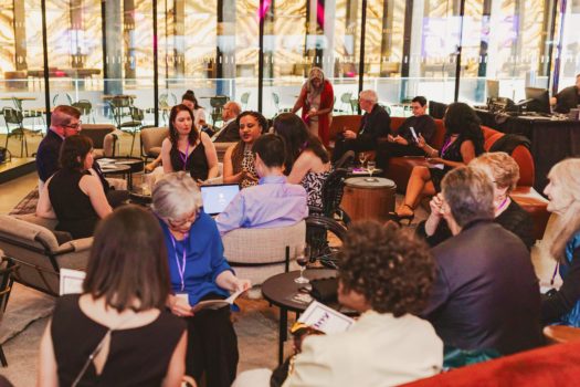 Gala attendees seated listening.