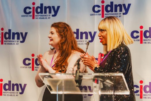 CIDNY's Dr. Sharon McLennon Wier and assistant speaking at a podium.