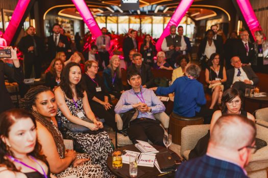 Gala attendees seated listening.