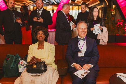 Gala attendees seated listening.