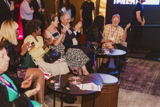 Gala attendees seated listening.