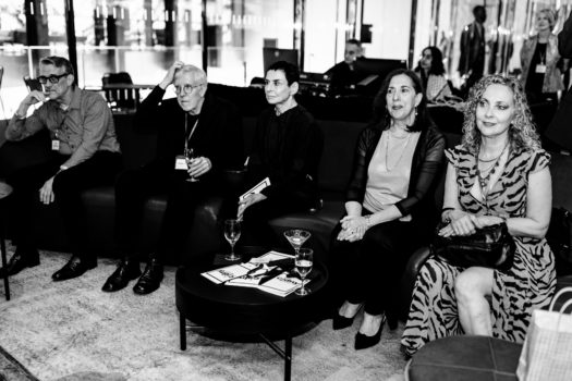 Gala attendees seated listening.