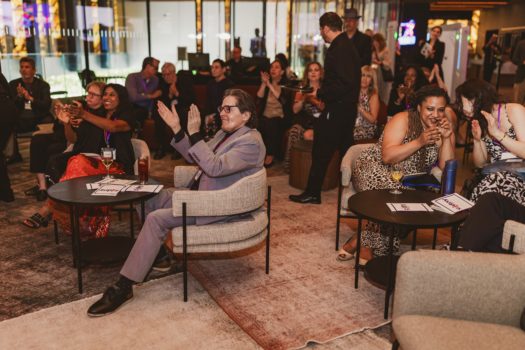 Gala attendees seated listening.