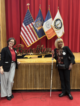 CIDNY's Sharon McLennon Wier and Rebekah Hurst standing in front of a sign that says ‘Brooklyn” at the 2025 Brooklyn State of the Borough Address.