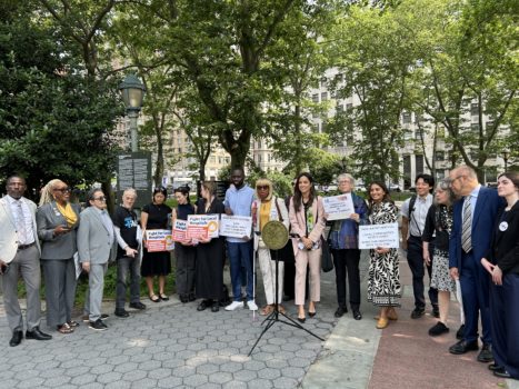 Select CIDNY staff with advocates gathered in a semicircle at Foley Square in support of the Local Input in Community Healthcare (LICH) Act.
