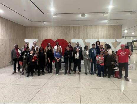 CIDNY staff along with community advocates gather in Albany in front of an I Love NY sign during CIDNY's 2026 Lobby Day.