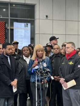 Dr. Sharon McLennon Wier, flanked by Brooklyn Borough President Antonio Reynoso and TWU 100 President John Chiarello, speaks outside the Jay St. Metrotech subway stationin Brooklyn.